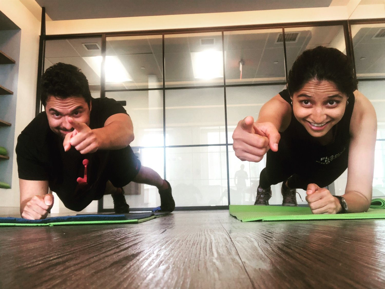 Two patients doing a plank exercise together in the studio